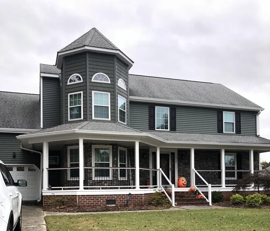 House with new windows, trim, siding, and gutter protection